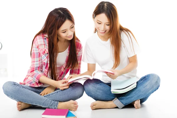 Dois adolescentes felizes estudantes meninas assistindo os livros — Fotografia de Stock