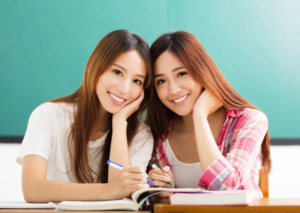 Two  happy teenage students girls in classroom — Stock Photo, Image