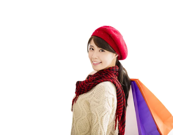 Happy young woman with winter wear and shopping bags — Stock Photo, Image