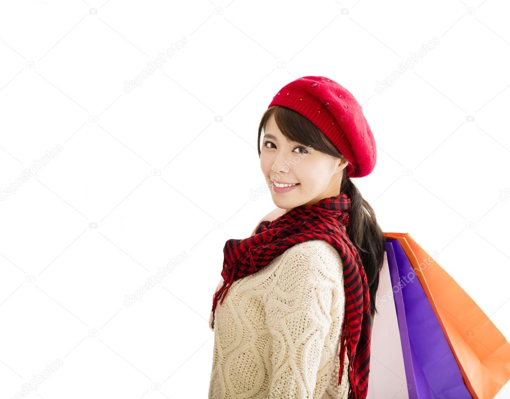 happy young woman with winter wear and shopping bags
