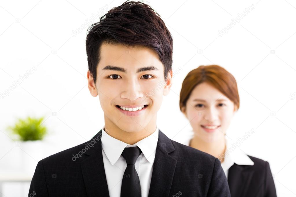 happy business man and woman standing  in office