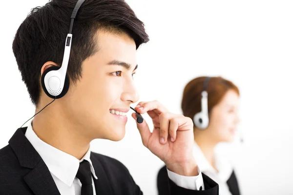 Young business people working with headset in office — Stock Photo, Image