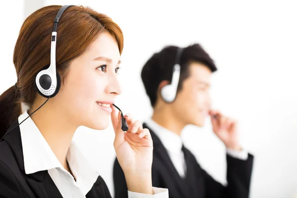 Young business people working with headset in office — Stock Photo, Image