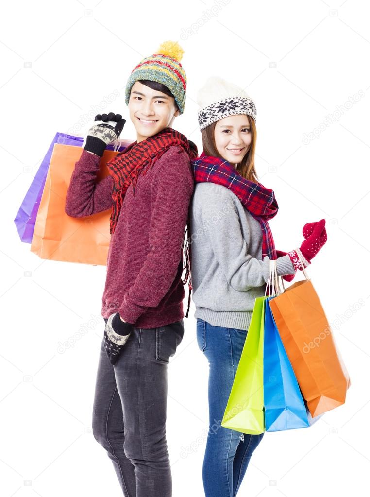 happy couple shopping together with winter wear