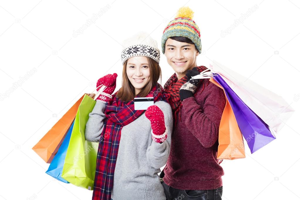 happy couple shopping together with winter wear