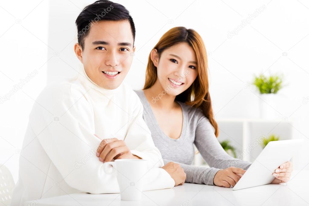 happy  Couple Looking at tablet In living room