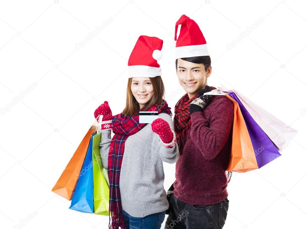 happy couple shopping together with christmas wear