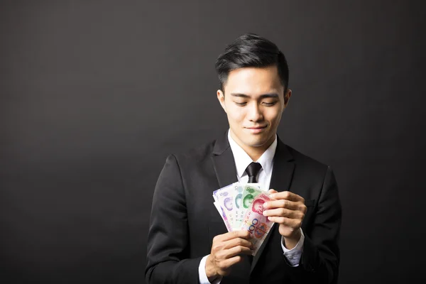 Business man holding yuan money in his hands — стоковое фото