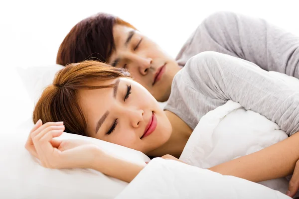 Happy young lovely couple lying in a bed — Stock Photo, Image