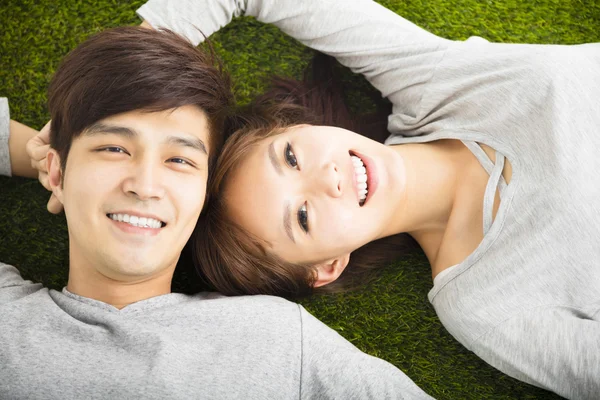 Happy Smiling Couple Relaxing on Green Grass — Stock Photo, Image