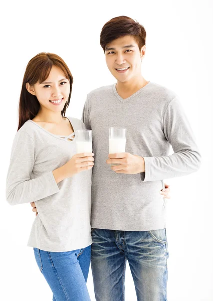 Young asian smiling couple drinking milk — Stock Photo, Image