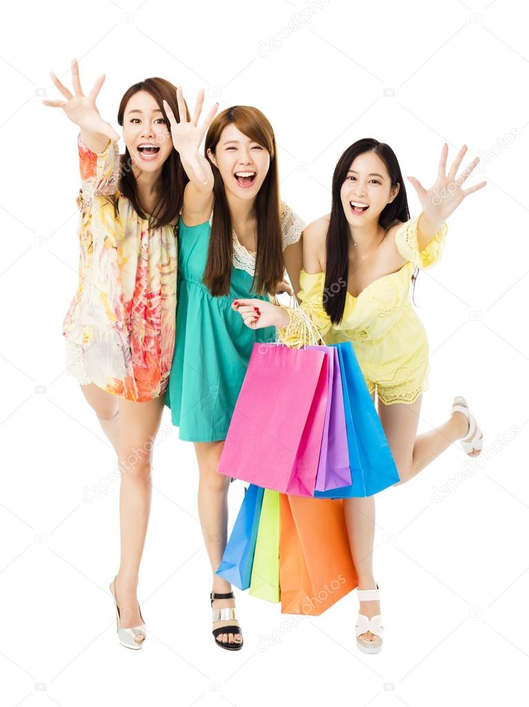 young woman group  with shopping bags running and catching