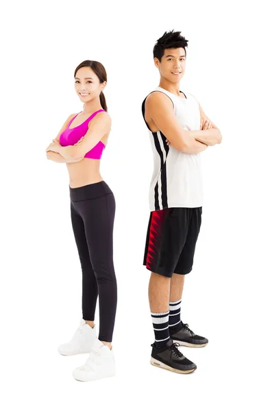 Mladý fitness pár stojí dohromady izolovaných na bílém — Stock fotografie