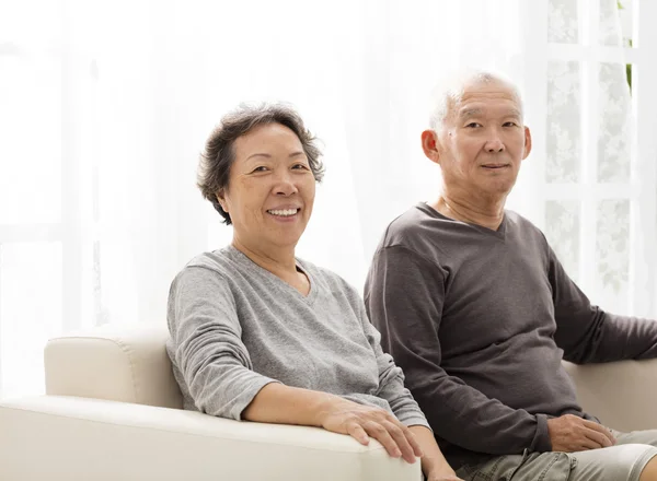 Senior couple sitting close together on the sofa — Stock Photo, Image