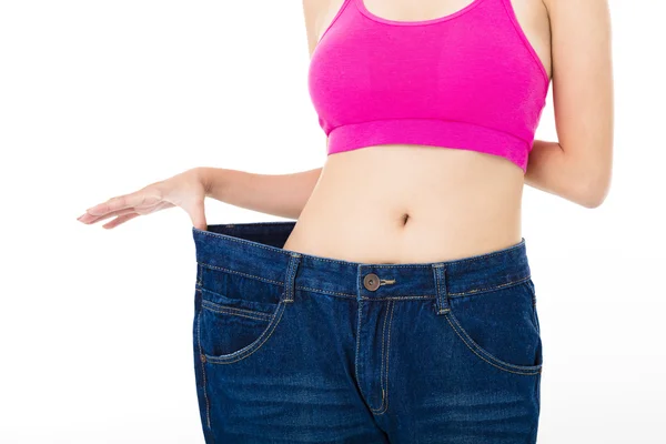 Beautiful slim young woman with big jeans — Stock Photo, Image