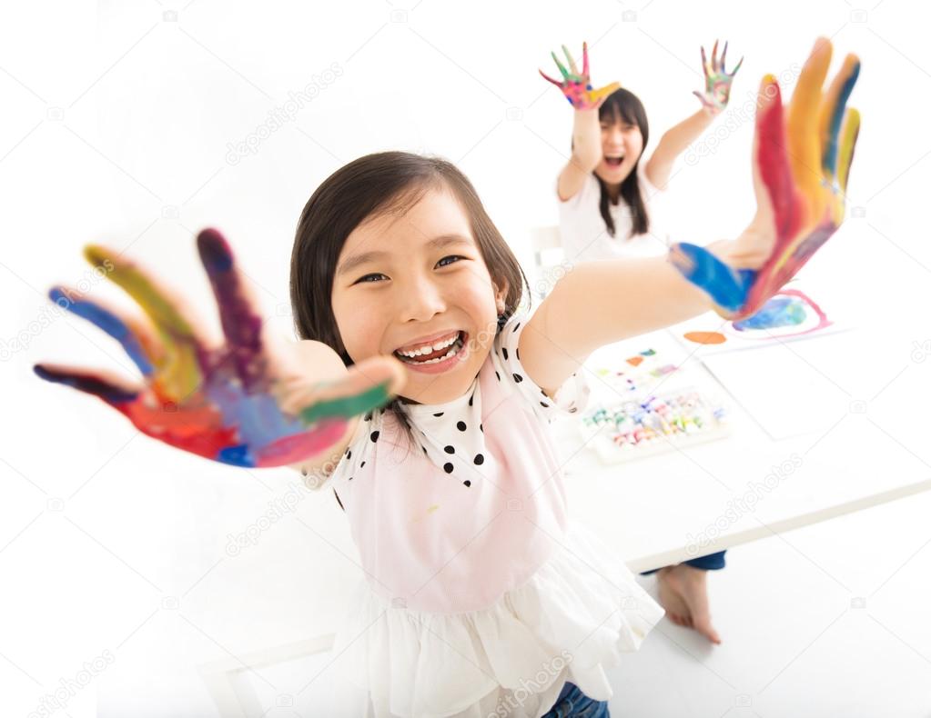 happy little girls with hands in the paint