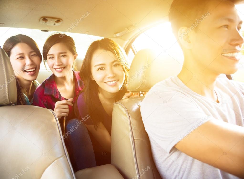young group people enjoying road trip in the car