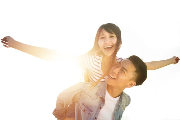 Šťastný mladý pár v lásce se slunečnímu záření pozadí — Stock fotografie