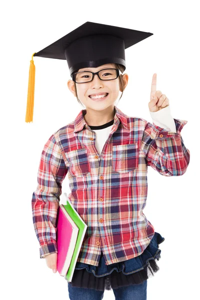 Happy school kid in graduation cap with success gesture — Stock Photo, Image