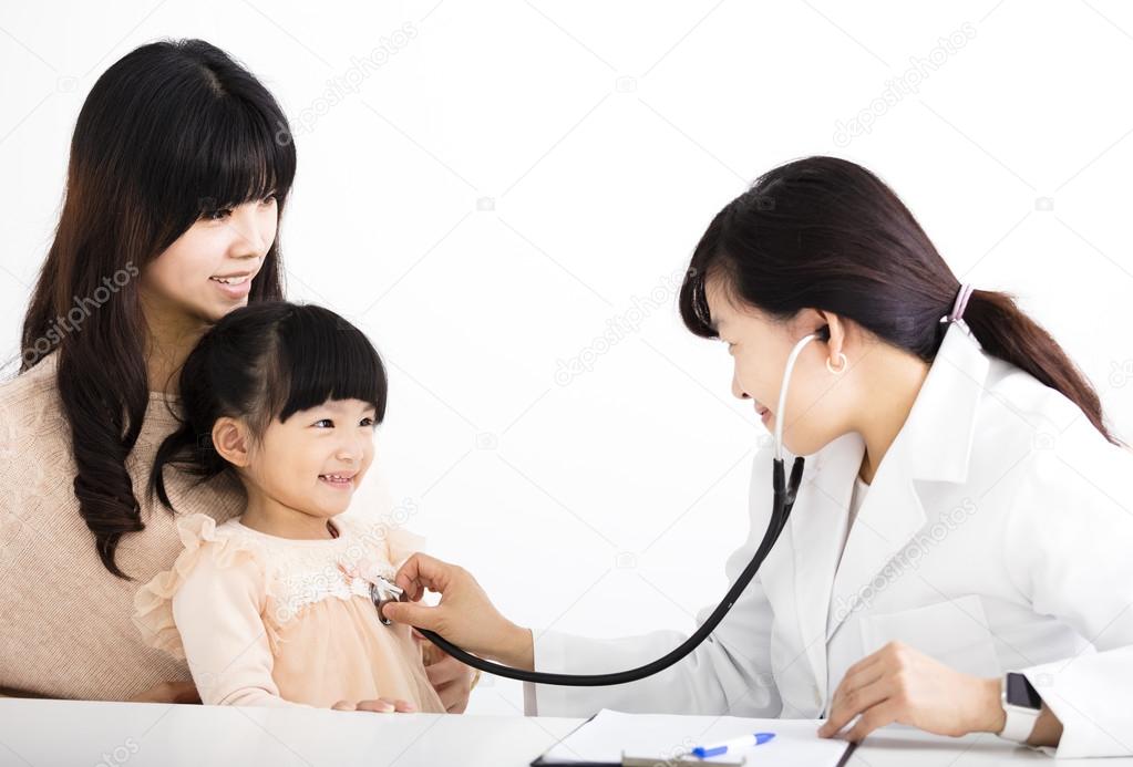 young female doctor examining a child patient