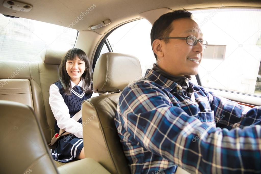 father driving to school with teen daughter