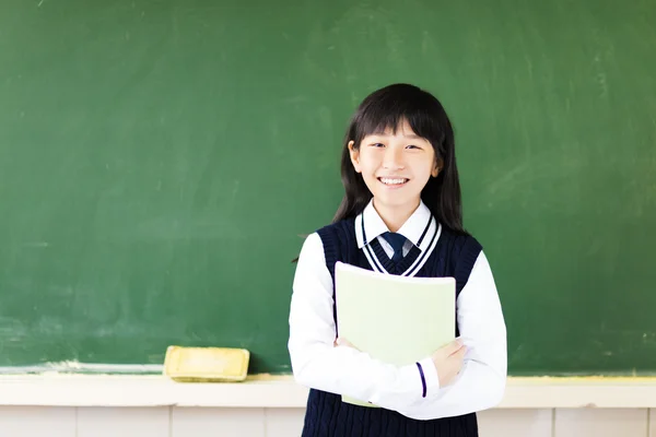 Chica estudiante feliz con libro en el aula — Foto de Stock