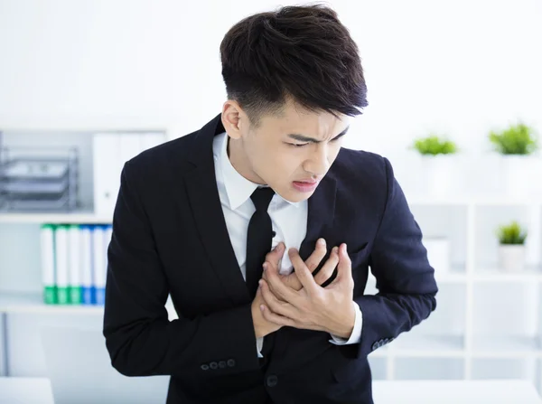 Young businessman having heart attack and chest pain — Stock Photo, Image