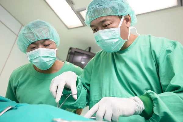 Surgeons during a surgery in the hospital — Stok fotoğraf