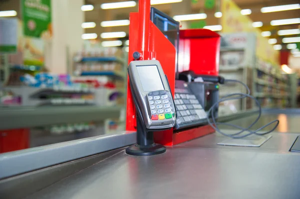 Cash desk with payment terminal in supermarket