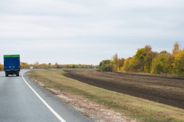 Trafiğin miktarı. Bulutlu sonbaharda şehirlerarası otoyol. Yol. Peyzaj