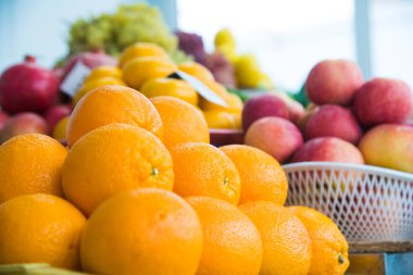 Güzel olgun portakallar diğer meyvelerin arka planına karşı güzelce istiflenir.