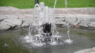 Jets of decorative fountain in the city park, close-up. 