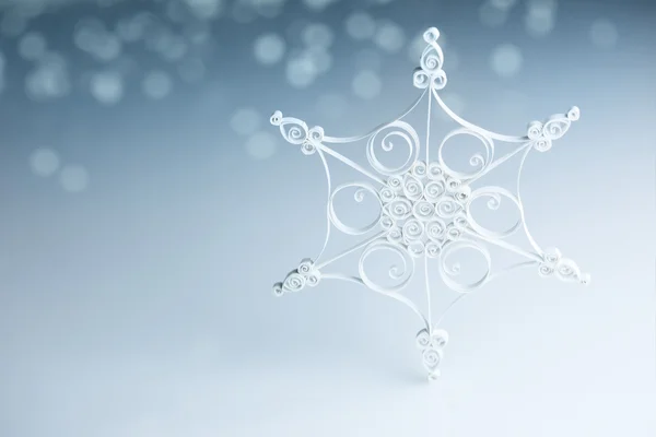 Beautiful white handmade quilling snowflake on blue - horizontal — Stock Photo, Image