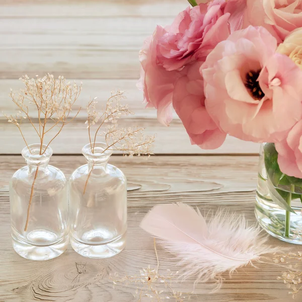 Vintage Still life with pink flowers in a vase with fearher and — Stock Photo, Image