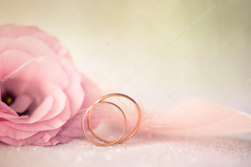 Wedding  Background with gold Rings and beautiful Eustoma rose f