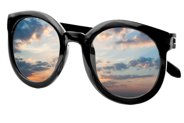 Sunglasses have a sunrise sky reflecting on  isolated  backgroun — Stock Photo, Image