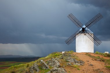 Old  Windmill on dramatic sky and rain clipart