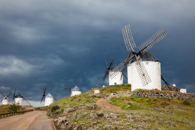 Old  windmills on dramatic sky and rainy weather clipart