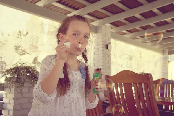 Girl blow bubbles — Stock Photo, Image