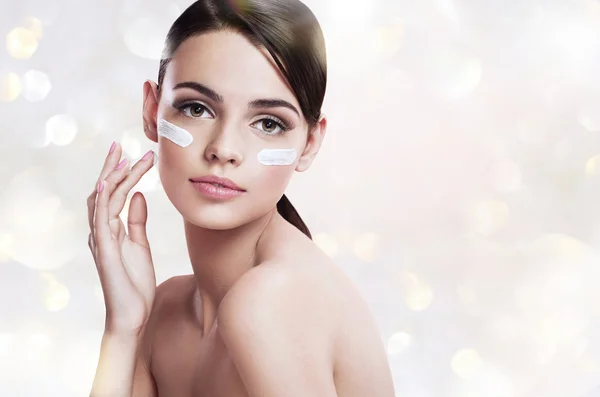 Skin care woman putting face cream