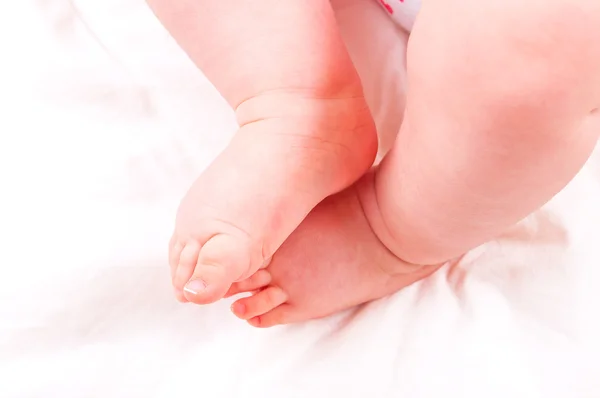 Neugeborene Babyfüße auf pinkfarbener Decke. — Stockfoto