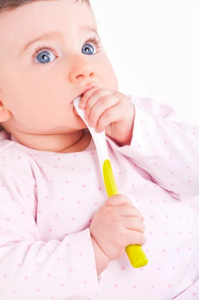 Baby girl with spoon. Royalty Free Stock Photos