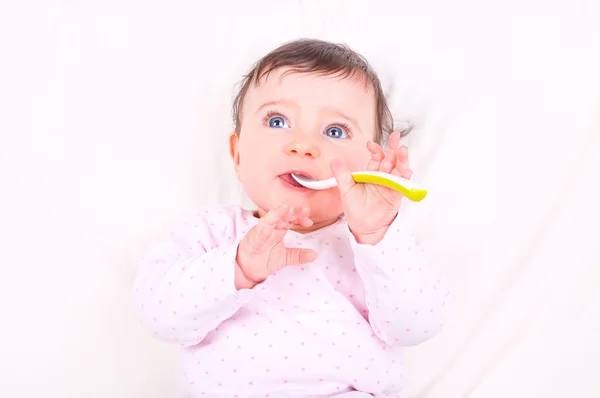 Baby girl with spoon. — Stock Photo, Image