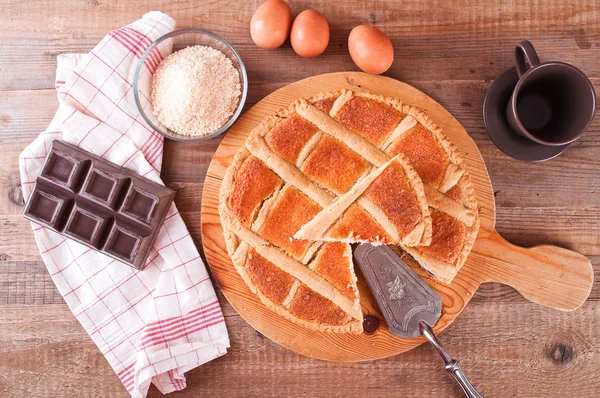 Chocolate coconut tart on wooden breadboard. — Stock Photo, Image