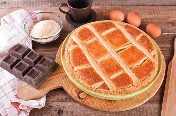 Chocolate coconut tart on wooden breadboard. — Stock Photo, Image