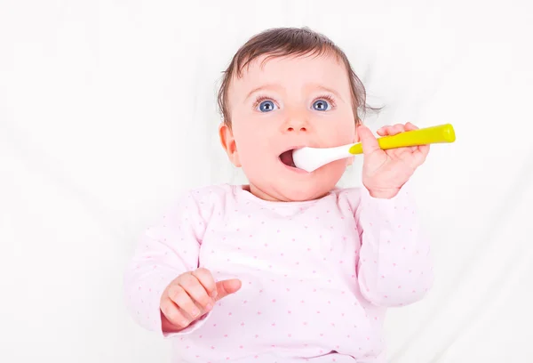 Baby girl with spoon. — Stock Photo, Image