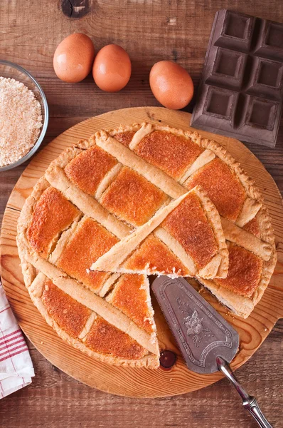 Chocolate coconut tart on wooden breadboard. — Stock Photo, Image