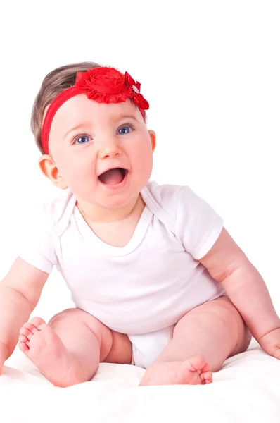 Babymeisje met rood lint. — Stockfoto