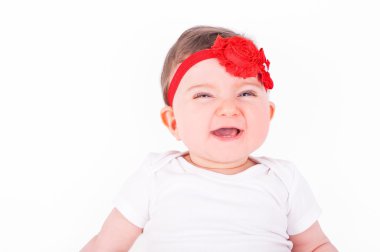 Baby girl with red ribbon.  clipart
