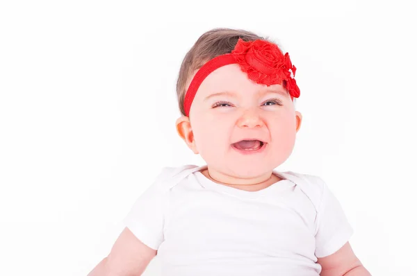 Babymeisje met rood lint. — Stockfoto